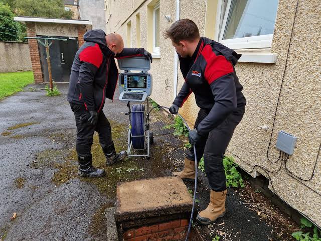 Technician conducting drain inspection